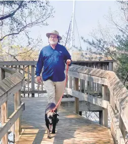  ?? JEFF HOLLAND ?? Jeff Holland and Millie climb the tiers of wooden stairs up the slope at Back Creek Nature Park and into the oak-and-holly woods.