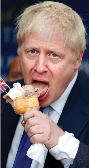  ??  ?? NO FLAGGING: Mr Johnson enjoys a treat on a visit to Barry Island yesterday