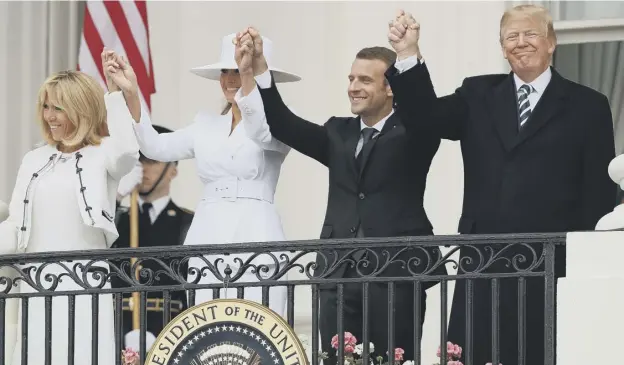  ?? PICTURE: GETTY IMAGES ?? 0 Donald Trump and French president Emmanuel Macron with wives Brigitte and Melania wave to invited guests from a White House balcony