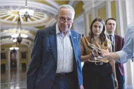  ?? PHOTOS J. SCOTT APPLEWHITE/ASSOCIATED PRESS ?? Senate Majority Leader Chuck Schumer, D-N.Y., talks with reporters Tuesday at the Capitol in Washington as the Senate returns to try to avert a government shutdown.