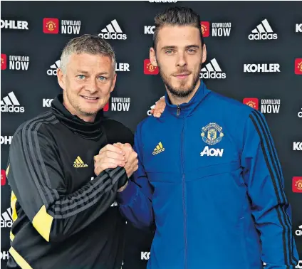  ??  ?? Long-term commitment: David de Gea (right) with Ole Gunnar Solskjaer after signing a new Manchester United contract