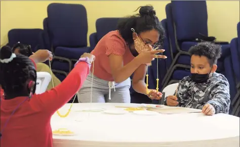  ?? Ned Gerard / Hearst Connecticu­t Media ?? Volunteer Addy Reyes works with second grader Cloe Baddoo Tuesday at the community learning hub at First Cavalry Baptist Church in New Haven.