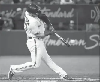  ?? PHOTOS BY NATHAN DENETTE, THE CANADIAN PRESS ?? Josh Donaldson hits a double in the sixth, for Toronto’s second hit off of rookie right-hander Paul Blackburn.