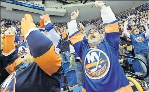  ?? CP PHOTO ?? New York Islanders fans cheer during the third period of an NHL hockey game against the Columbus Blue Jackets in Uniondale, N.Y., on April 11, 2015. The wave can be as polarizing as a ballpark frank — some fans enjoy it as part of the stadium...