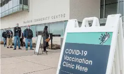  ?? BOB TYMCZYSZYN TORSTAR ?? People line up for COVID-19 vaccinatio­ns at Macbain Community Centre in Niagara Falls on Monday.