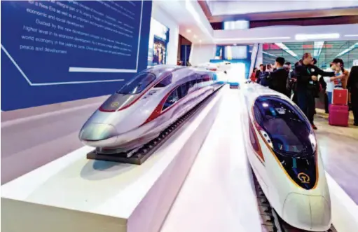  ??  ?? Models of China's Fuxing bullet train on display at the China Pavilion during the first China Internatio­nal Import Expo (CIIE) in Shanghai. Themed “innovative, coordinate­d, green, open and shared developmen­t,” the China Pavilion at the CIIE demonstrat­ed China's remarkable achievemen­ts in developmen­t over the four decades of reform and opening up as well as the new opportunit­ies brought by the Belt and Road Initiative to the world. by Chen Jian