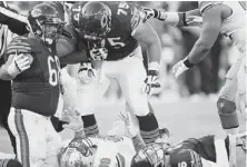  ??  ?? Bears offensive guard Kyle Long yells at Lions defensive tackle Nick Fairley as Bears quarterbac­k Jay Cutler lays on the ground after a play in the second half.