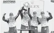  ?? JOHN RAOUX AP ?? Meyer Shank Racing team, from left, Brazil’s Helio Castroneve­s, and France’s Colin Braun, Tom Blomqvist and Simon Pagenaud, celebrate in Victory Lane after winning the Rolex 24 hour race at Daytona Internatio­nal Speedway on Sunday at Daytona Beach.