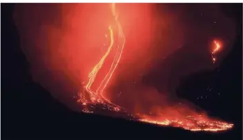  ?? FOTOS: DPA ?? Ein spektakulä­res Bild: Die Lava fließt am Ätna ins Tal. Experten zufolge hat sich durch die Eruption ein zwei Kilometer langer Spalt aufgetan. Der Vulkan ist mehr als 3300 Meter hoch und damit einer der höchsten Europas.