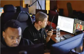  ?? HYOSUB SHIN / HYOSUB.SHIN@AJC.COM ?? Atlanta police Officers Antwoin Williams (foreground) and Charles Schiffbaue­r monitor surveillan­ce cameras recently at Loudermilk Video Integratio­n Center in Atlanta. If you’re in Atlanta, you’re probably on camera.