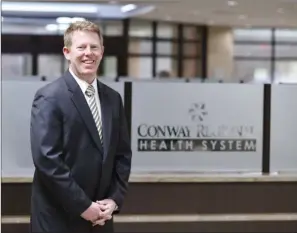  ?? KELVIN GREEN/RIVER VALLEY & OZARK EDITION ?? Matt Troup stands inside Conway Regional Medical Center. Troup, 46, became the president and CEO of the Conway Regional Health System in August through a five-year management agreement with CHI St. Vincent. “I love what I do; I have a lot of passion around what I do,” he said.