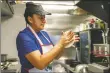  ?? ?? Amelia Mejia, owner of Amelia Salvadoria­n Food, makes tortillas early Tuesday (Oct. 19).