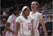  ?? GODOFREDO A. VÁSQUEZ — THE ASSOCIATED PRESS ?? Stanford guard Indya Nivar (12) celebrates with forward Cameron Brink, right, after a block against USC during the first half in Stanford on Friday.