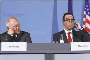  ?? Michele Tantussi / Getty Images ?? German Finance Minister Wolfgang Schaeuble (left) and U.S. Treasury Secretary Steven Mnuchin speak at a media session after they met ahead of the conference of finance ministers from the Group of 20 nations.