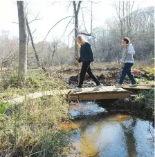  ?? PAUL W. GILLESPIE/BALTIMORE SUN MEDIA GROUP ?? Heart Month is a good time to get into a better exercise routine. Here, hikers make their way over a bridge in the Bacon Ridge Natural area in Crownsvill­e.