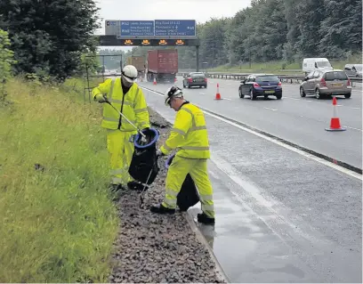  ??  ?? ●●Litter picking team hard at work Greater Manchester’s motorways