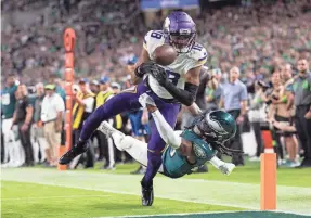  ?? BILL STREICHER/USA TODAY SPORTS ?? Vikings receiver Justin Jefferson fumbles the ball out of bounds in the end zone while being tackled by the Eagles’ Terrell Edmunds.