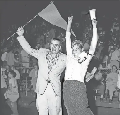  ?? THE COMMERCIAL APPEAL ?? Harmon Colvett of Bartlett and Eleanor Mcginnis of Memphis cheer as Ole Miss beats Kentucky 28-9 in the second half of a doublehead­er at Crump Stadium on Sept. 25, 1954. Tennessee beat Mississipp­i State in the other game.