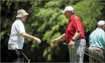  ?? RICK KAUFFMAN — DIGITAL FIRST MEDIA ?? Norm Kropp, right, shakes hands with his younger brother Ken Kropp, left, after a round golf in the Delaware County Senior Games at Paxon Hollow Country Club Wednesday. of