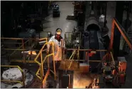  ?? LUKE SHARRETT — BLOOMBERG ?? A worker oversees molten iron during cookware production at a factory in South Pittsburg, Tenn., on March 7.