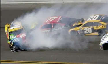  ?? DARRYL GRAHAM — THE ASSOCIATED PRESS ?? Erik Jones (77) and Matt Kenseth (20) collide with Kyle Busch (18) during the Daytona 500 on Feb. 26 at Daytona Internatio­nal Speedway in Daytona Beach, Fla.