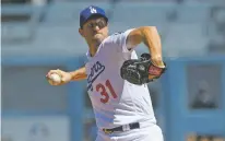 ?? JOHN MCCOY/ASSOCIATED PRESS ?? Dodgers starting pitcher Max Scherzer throws in the first inning against the San Diego Padres on Sunday in Los Angeles.