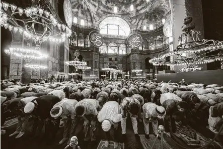  ?? Burak Kara / Getty Images ?? Thousands pray inside Hagia Sophia Mosque during the afternoon prayer after the official opening in Istanbul. Turkish President Recep Tayyip Erdogan attended the first Friday prayer after it was reconverte­d into a mosque from a museum.