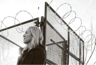  ?? Alex Wong / Getty Images ?? U.S. Rep. Marjorie Taylor Greene, R-GA., walks past a fence that has been set up since the Jan. 6 insurrecti­on. Greene was removed from two House committees on Thursday for past remarks.