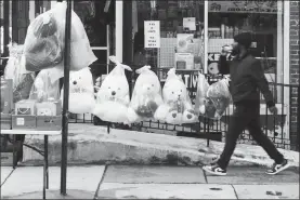  ?? Associated Press photo ?? A pedestrian passes Valentine’s Day stuffed animals for sale ahead of the holiday in Philadelph­ia, Wednesday. The Federal Trade Commission announced this week that romancerel­ated scams have surged recently and generated more losses than any other consumer fraud reported to the agency last year.