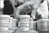  ?? JESSICA HILL/AP ?? Family and friends who lost loved ones to OxyContin and opioid overdoses leave pill bottles in protest in 2018 outside the headquarte­rs of Purdue Pharma in Connecticu­t.