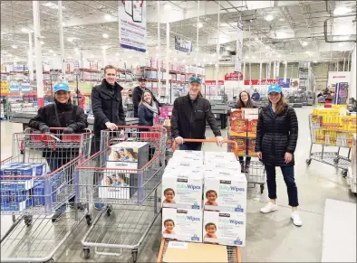  ?? Contribute­d photo ?? Priceline CEO Brett Keller, second from left, with colleagues at Costco in Norwalk on Nov. 21 as part of Priceline's Thanksgivi­ng charitable drive that raised nearly $100,000 supporting the Food Bank of Lower Fairfield County.
