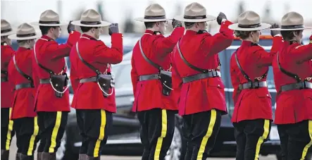  ?? CODIE MCLACHLAN ?? RCMP officers line the road on Jan. 26, 2015, to salute as the hearse containing the remains of Cst. David Wynn. The Mountie’s killing by a man recently released on bail prompted a review of Alberta’s bail system, leading to a new set-up that sees a...