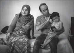  ?? BRIAN CASSELLA/CHICAGO TRIBUNE FILE PHOTOGRAPH ?? Baraa, Abdulmajee­d and Sham Haj Khalaf sit in the living room of their Skokie, Ill. home on July 23. The family emigrated as refugees from Syria.