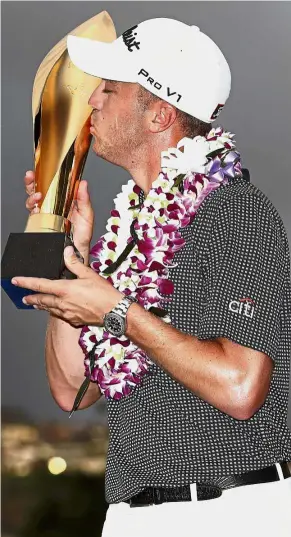  ??  ?? Sealed with a kiss: Justin Thomas kissing the trophy after winning the Sony Open in Hawaii on Sunday. — AFP