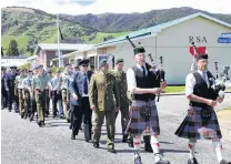  ?? PHOTO: JOHN COSGROVE ?? On parade . . . Servicemen and women march through the centre of Tapanui to commemorat­e the end of World War 1 during a gala street party held there.