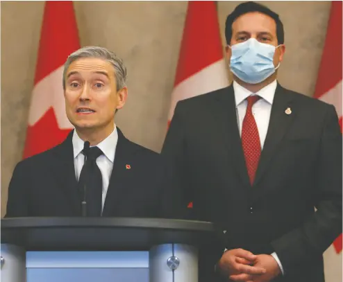  ?? DAVID KAWAI / THE CANADIAN PRESS ?? Minister of Innovation, Science and Industry François-philippe Champagne, left, and Minister of Public Safety
Marco Mendicino announce Thursday that Huawei Technologi­es will be banned from Canada’s 5G networks.