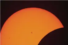  ?? Julio Cortez/Associated Press ?? Sunspots are seen during the beginning phase of a total solar eclipse seen from Arlington, Texas.