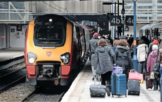  ?? JACK BOSKETT. ?? Passengers head towards a Glasgow Central-bound Virgin Super Voyager Class 221 at Birmingham New Street on March 22 2013. The issue of pollution endangerin­g passengers at stations is becoming political, with Wolmar highlighti­ng Birmingham New Street as...