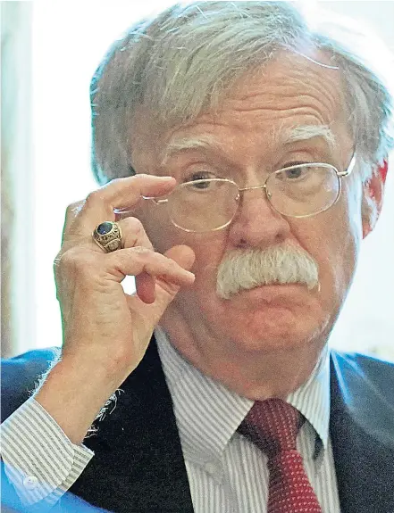  ??  ?? John Bolton, the new national security adviser listens as Donald Trump holds a cabinet meeting at the White House. When asked if he was considerin­g military action, Mr Trump said: ‘We’ll be making that decision very quickly’