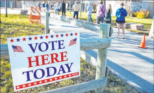  ?? Tommy Martino The Associated Press ?? A federal judge in Montana temporaril­y blocked a law that appeared to require people to cancel previous voter registrati­ons before signing up to vote in Montana or possibly face criminal charges. An attorney for the plaintiffs said the law wasn’t clear.