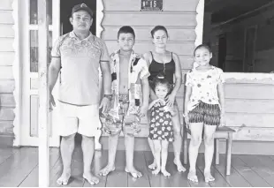  ?? AP/FABIANO MAISONNAVE ?? LAURIMAR LOPES ALVES, who goes by Caboclo, poses for a photo with his family at their home in Benjamin Constant, Amazonas state, Brazil, March 2, 2023. One year ago, Caboclo met Bruno Pereira, an expert on Indigenous communitie­s, and Dom Phillips, a British journalist, shortly before they were killed. The Associated Press returned to the Javari Valley ahead of the anniversar­y to describe the place where the two were killed.