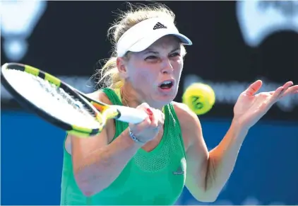  ??  ?? Caroline Wozniacki of Denmark plays a shot to Monica Puig of Puerto Rico