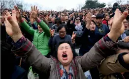  ?? — AP ?? South Korean Christians pray during an annual Easter service rally at Yeonsei University in Seoul on Sunday. About 10,000 participan­ts prayed for peace and de- nuclearisa­tion on the Korean Peninsula.