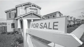  ?? Associated Press file photo ?? A jump in borrowing costs, adding hundreds of dollars a month to the typical mortgage payment, pushes some wishful homebuyers past their financial limits.