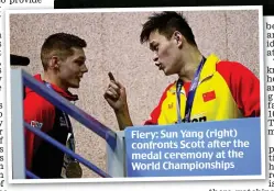  ??  ?? Fiery: Sun Yang (right) confronts Scott after the medal ceremony at the World Championsh­ips