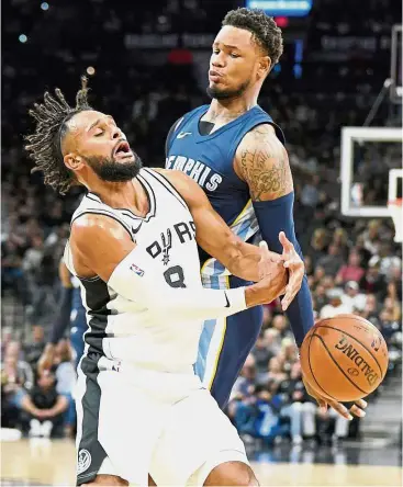  ?? — AP ?? Oops!: San Antonio Spurs guard Patty Mills ( left) colliding with Memphis Grizzlies guard Ben McLemore during the second half of their NBA game on Wednesday.