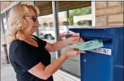  ?? Buy this photo at YumaSun.com PHOTO BY RANDY HOEFT/YUMA SUN ?? JANET SELLERS DROPS an early Yuma city election ballot into the box outside the Yuma County Recorders Office, 197 S. Main St., Tuesday morning.