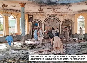  ?? ?? People view the damage inside of a mosque following a bombing in Kunduz province northern Afghanista­n