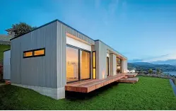  ?? ARCHITECTU­RAL DESIGNERS NEW ZEALAND ?? Karsten Architectu­ral Design Ltd’s Atawhai House, a four-bedroom family home sitting high above Nelson Haven, has a long, low form and cladding that blends well with the surroundin­g vegetation.