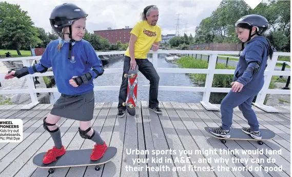  ??  ?? WHEEL PIONEERS Kids try out skateboard­s. Pic: Phil Dye PLAY ON